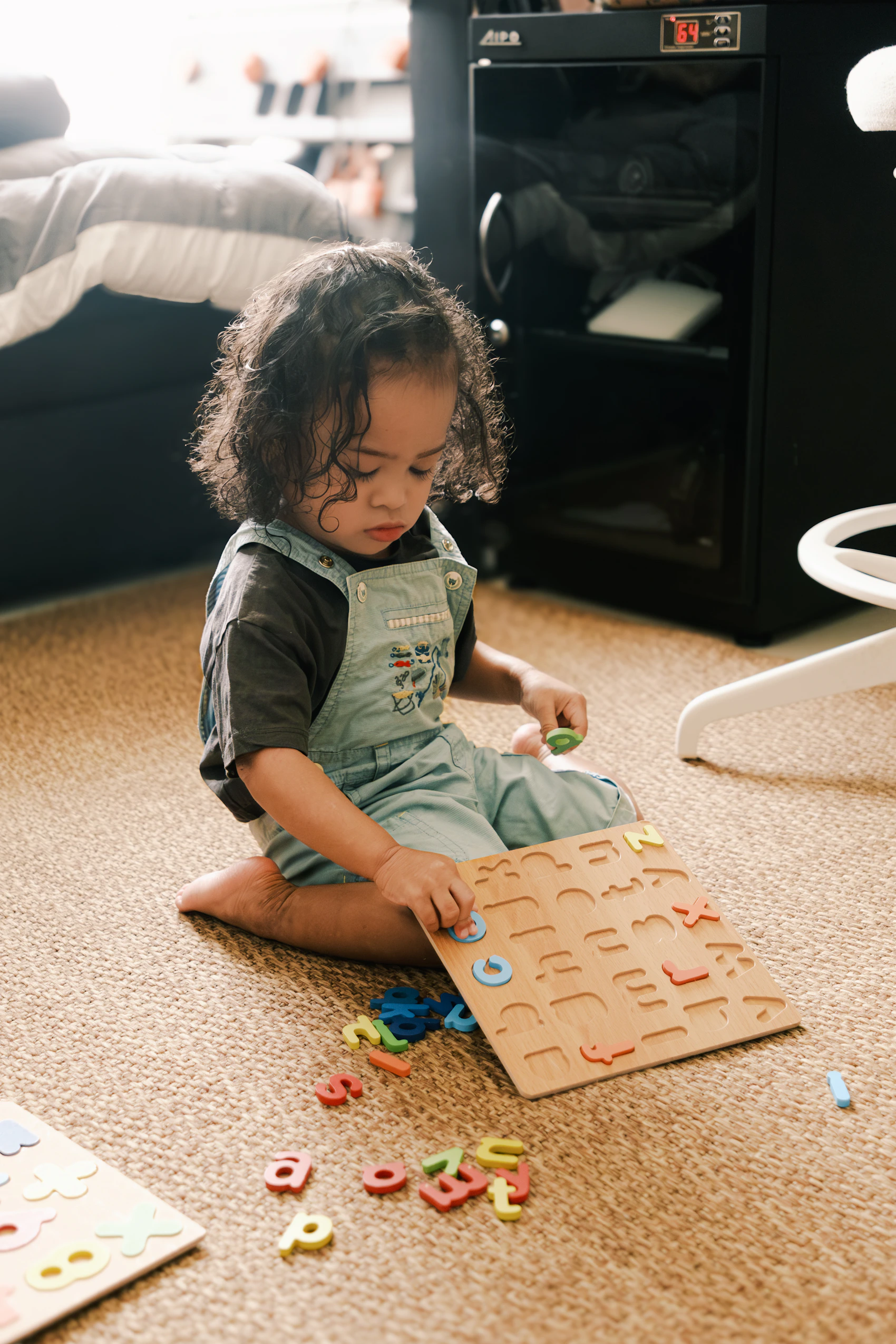 Child exploring an educational alphabet puzzle during play