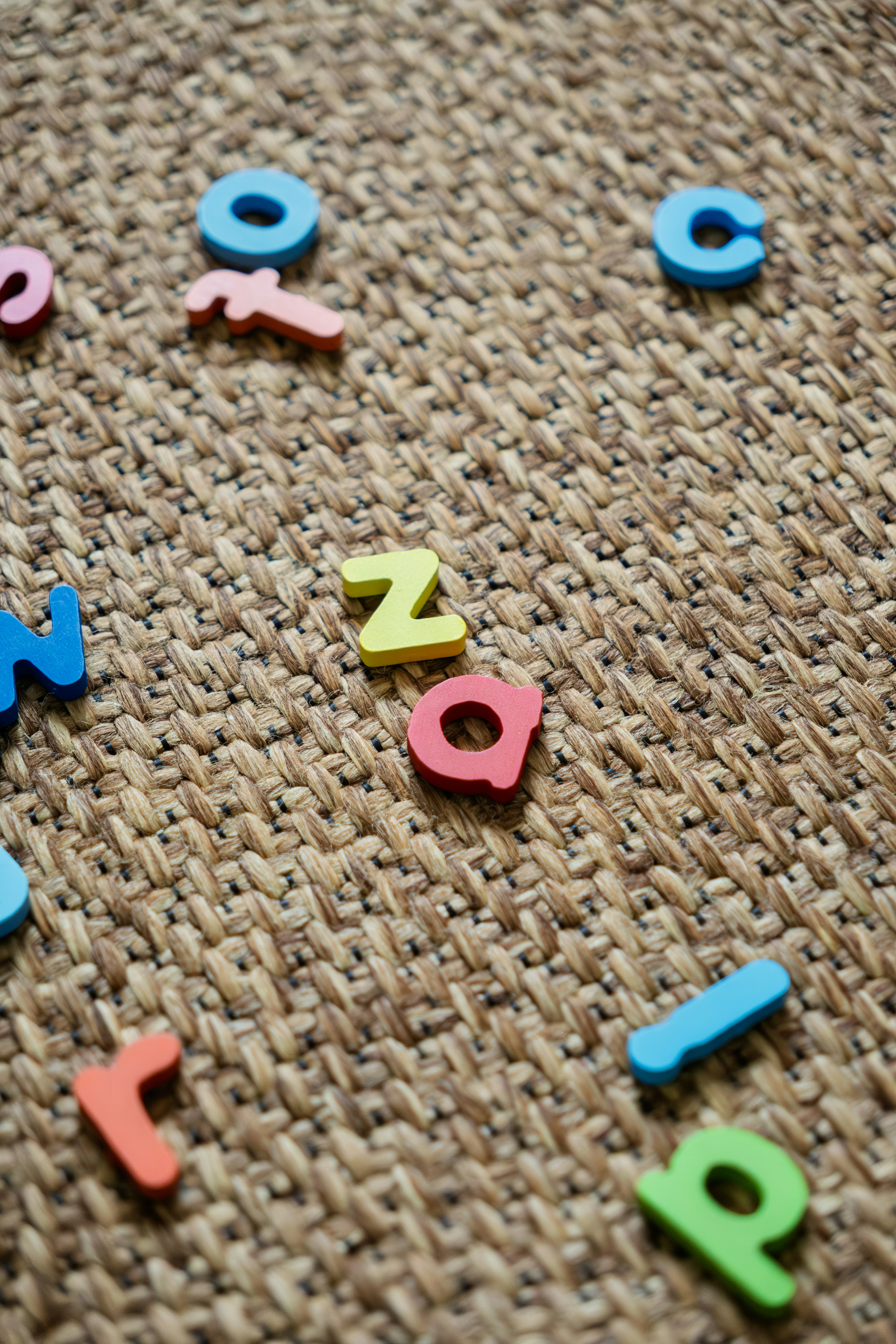 Colorful letters scattered on a textured surface.