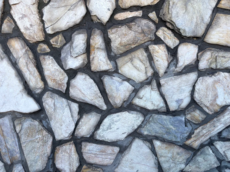 Fieldstone wall with hand-set stones and dark mortar joints
