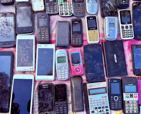 A collection of various old mobile phones and devices.