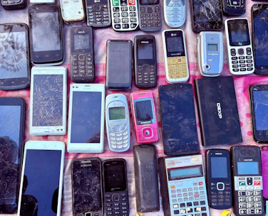A collection of various old mobile phones and devices.