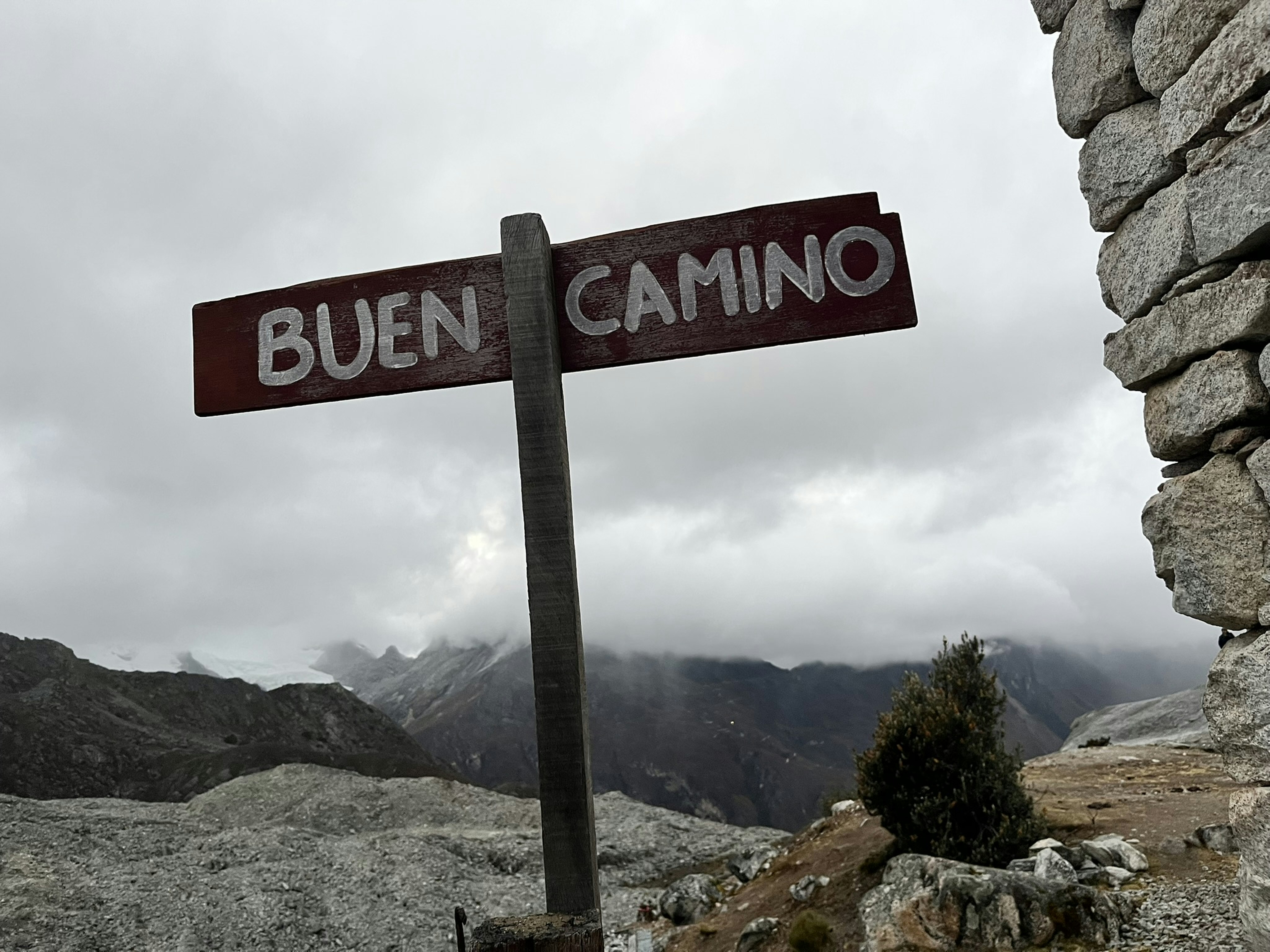 Buen camino signpost with mountains in background