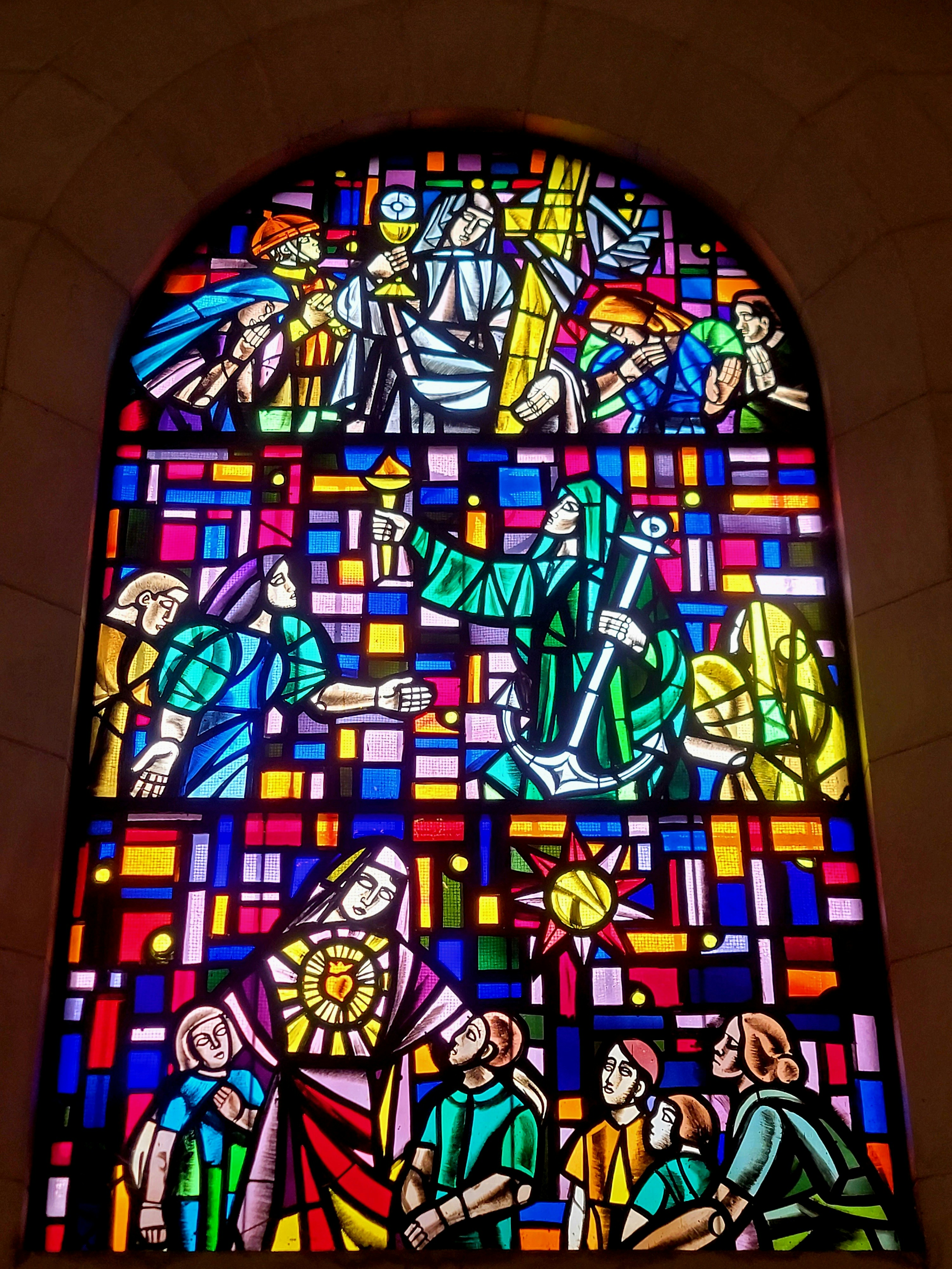 Colorful stained glass window depicting religious scenes