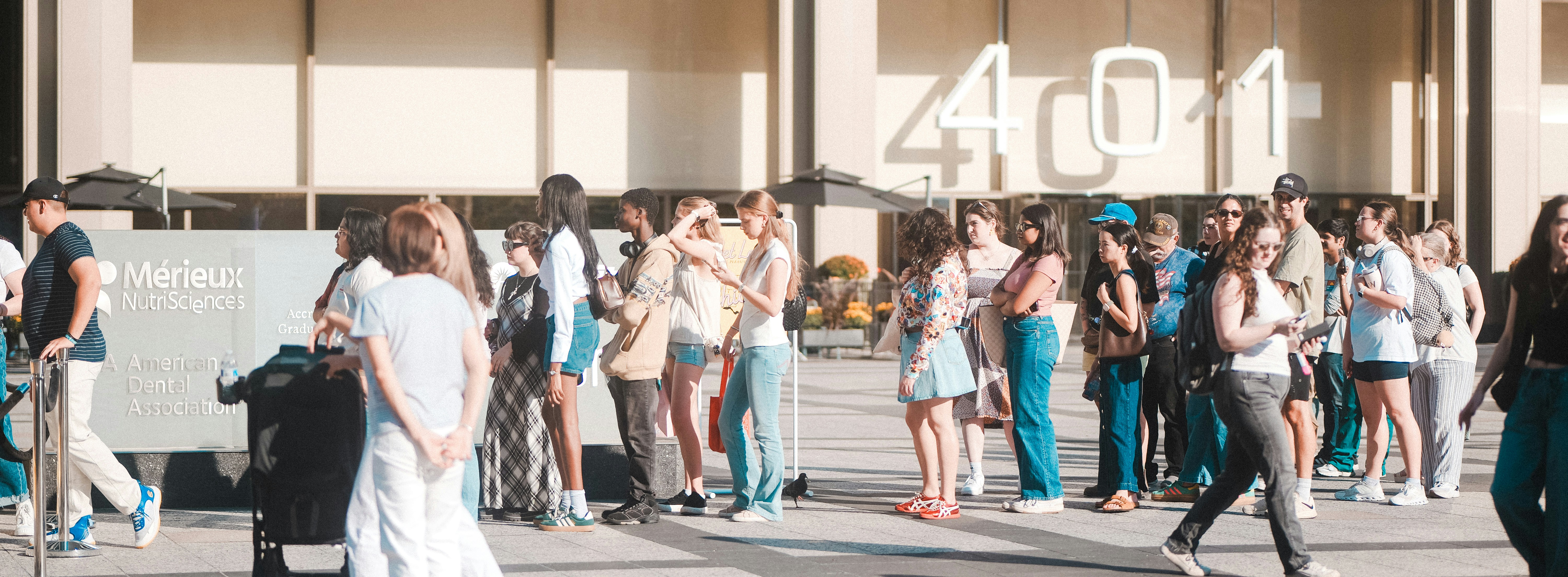 A group of people waiting outside a building