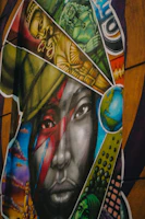 Graffiti art features a striking portrait with diverse imagery.