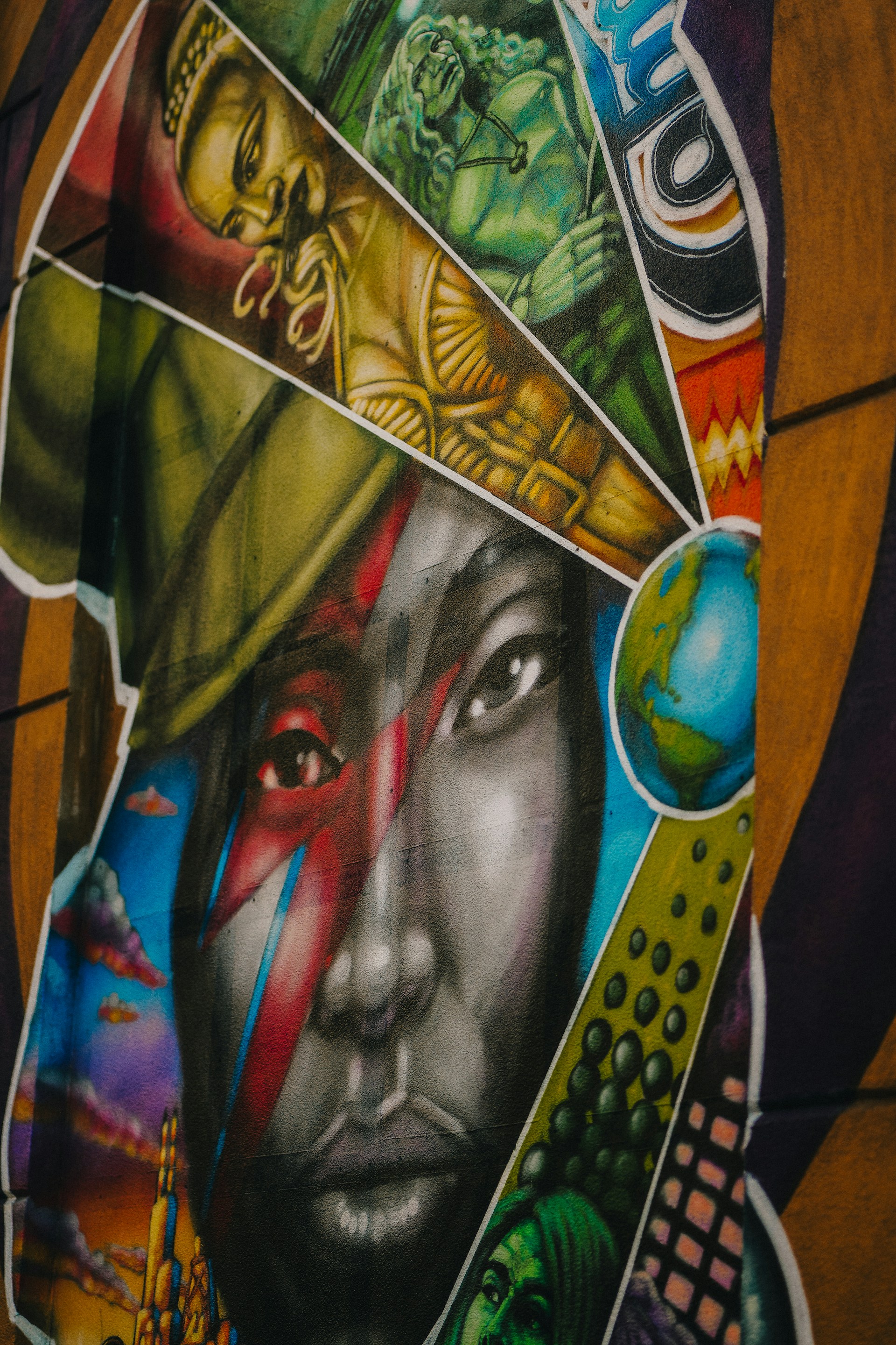 Graffiti art features a striking portrait with diverse imagery.