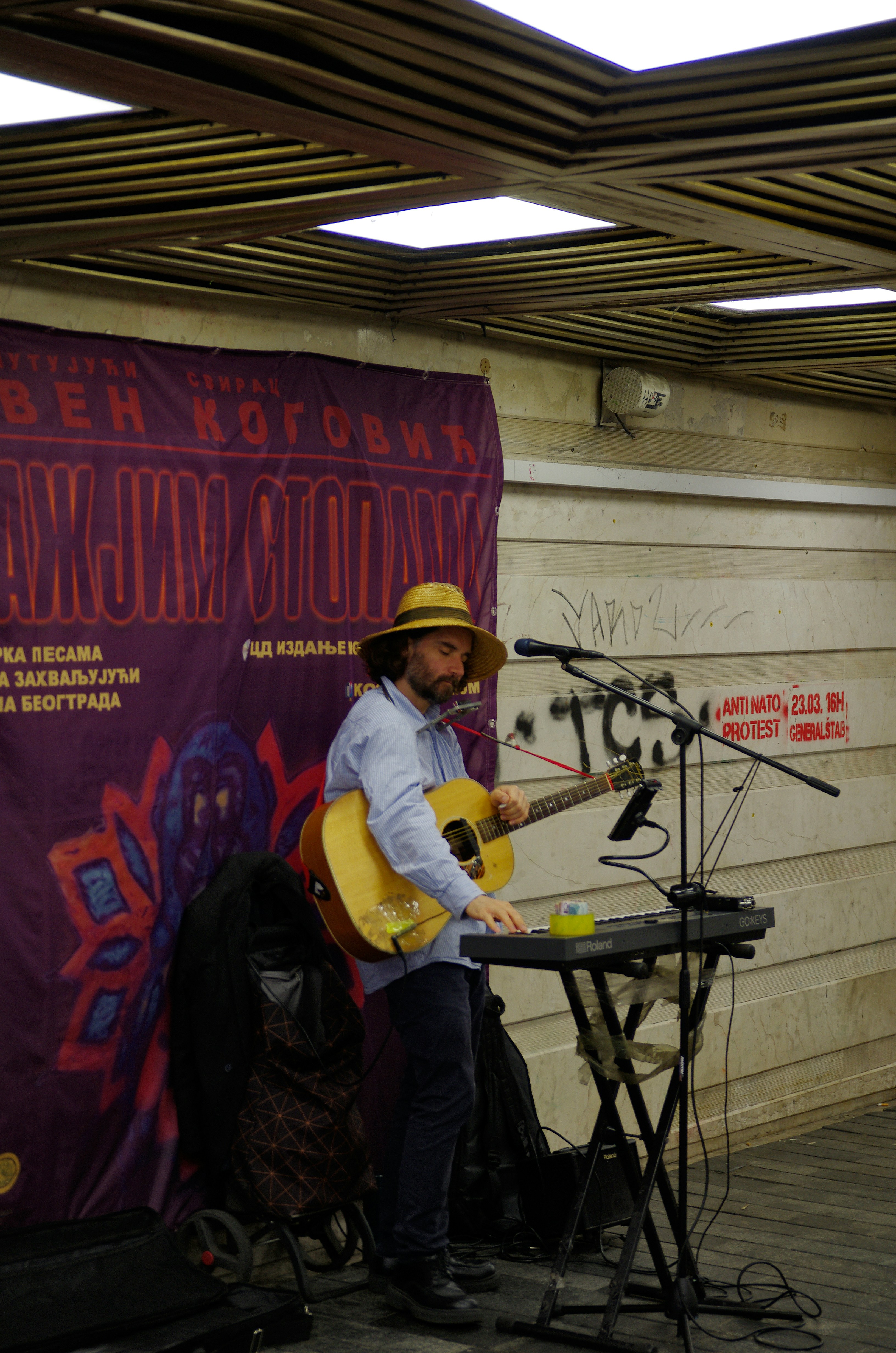 Man playing guitar and keyboard on stage