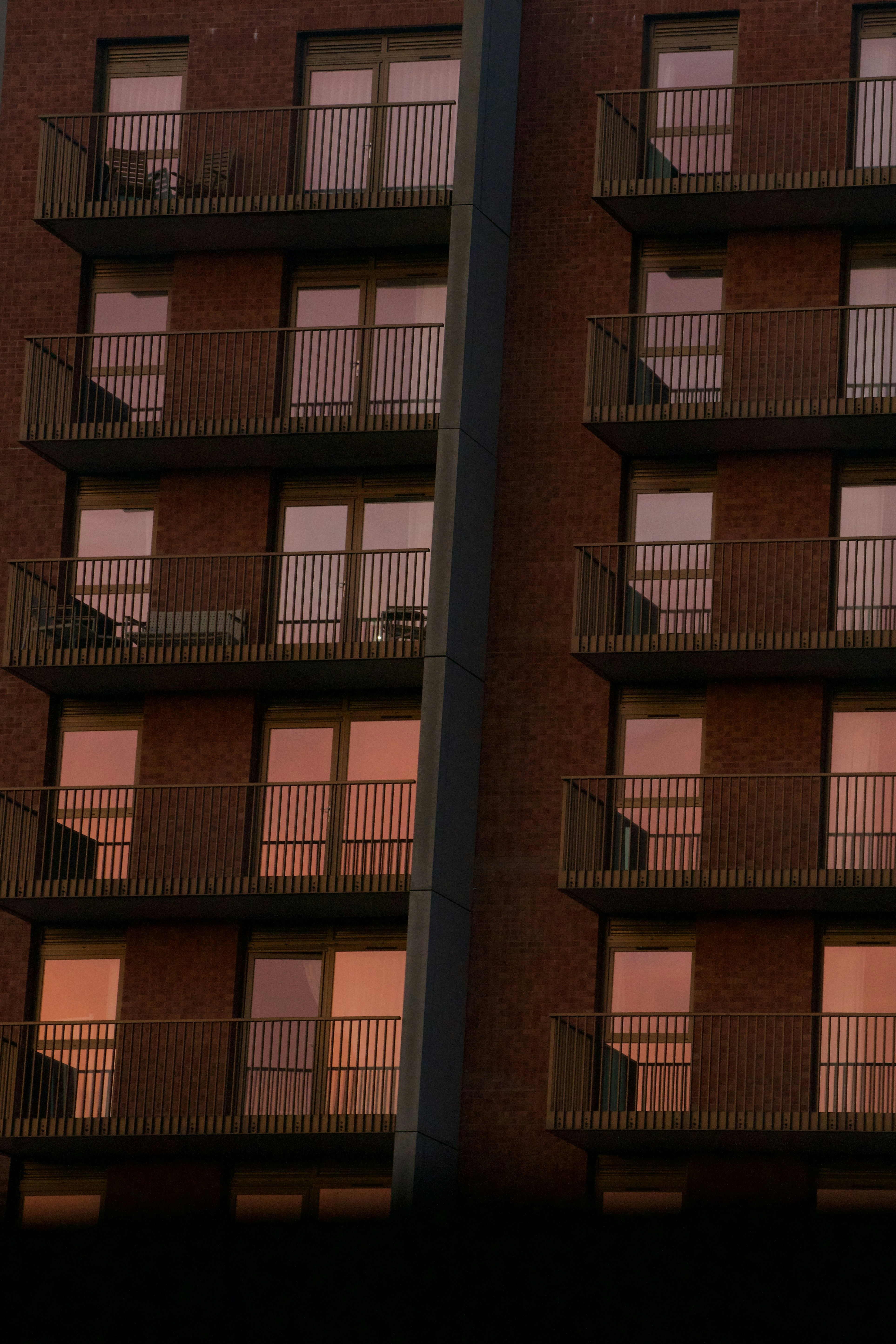 Modern brick building with balconies at sunset photo – Free Building ...