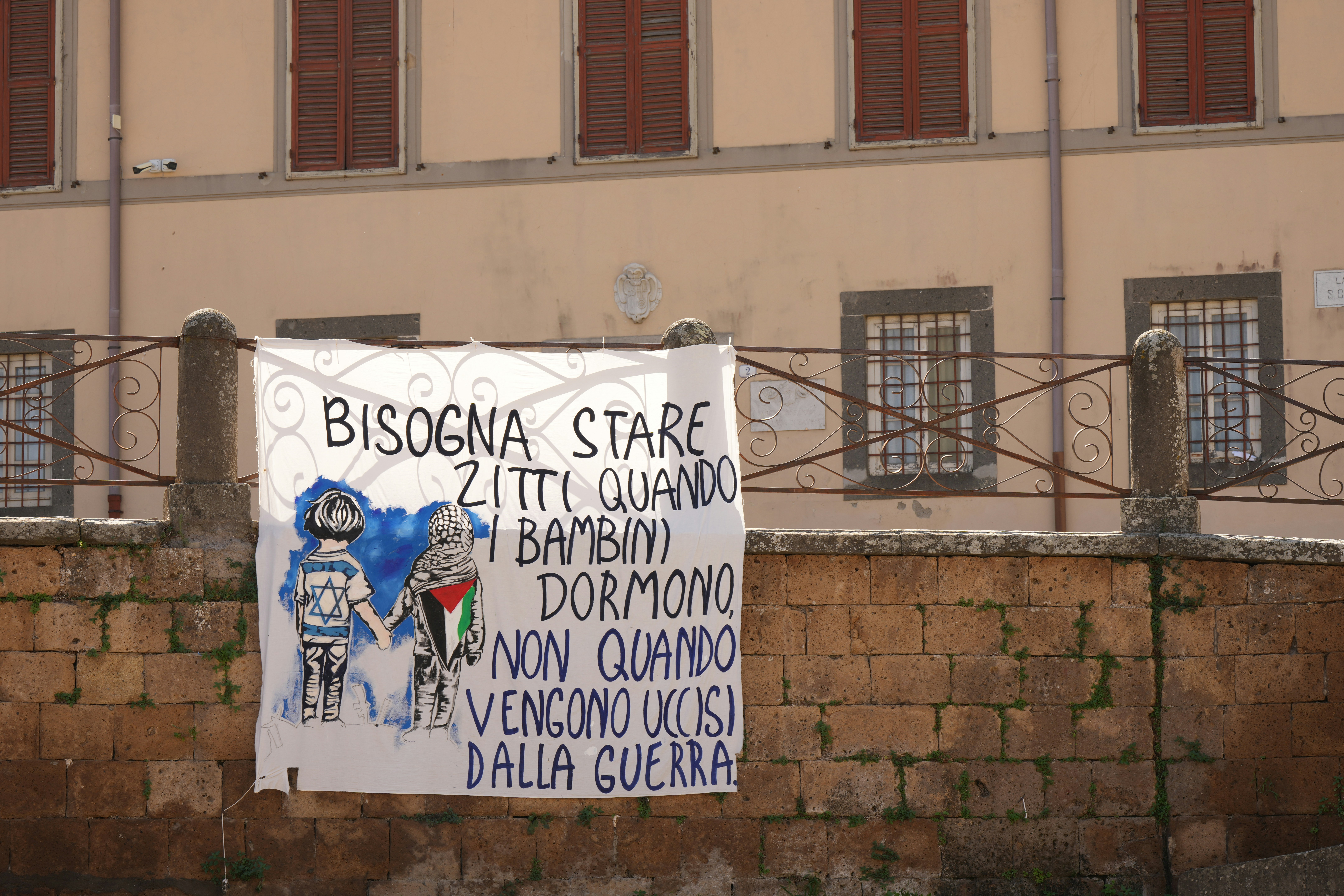Banner with text and drawings about children and war.