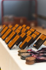 Rows of awards and medals displayed on a table.