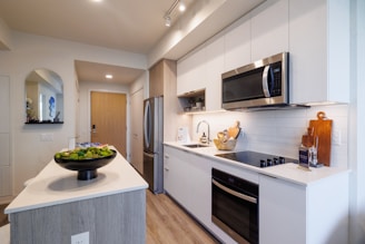 Modern kitchen with stainless steel appliances and island.