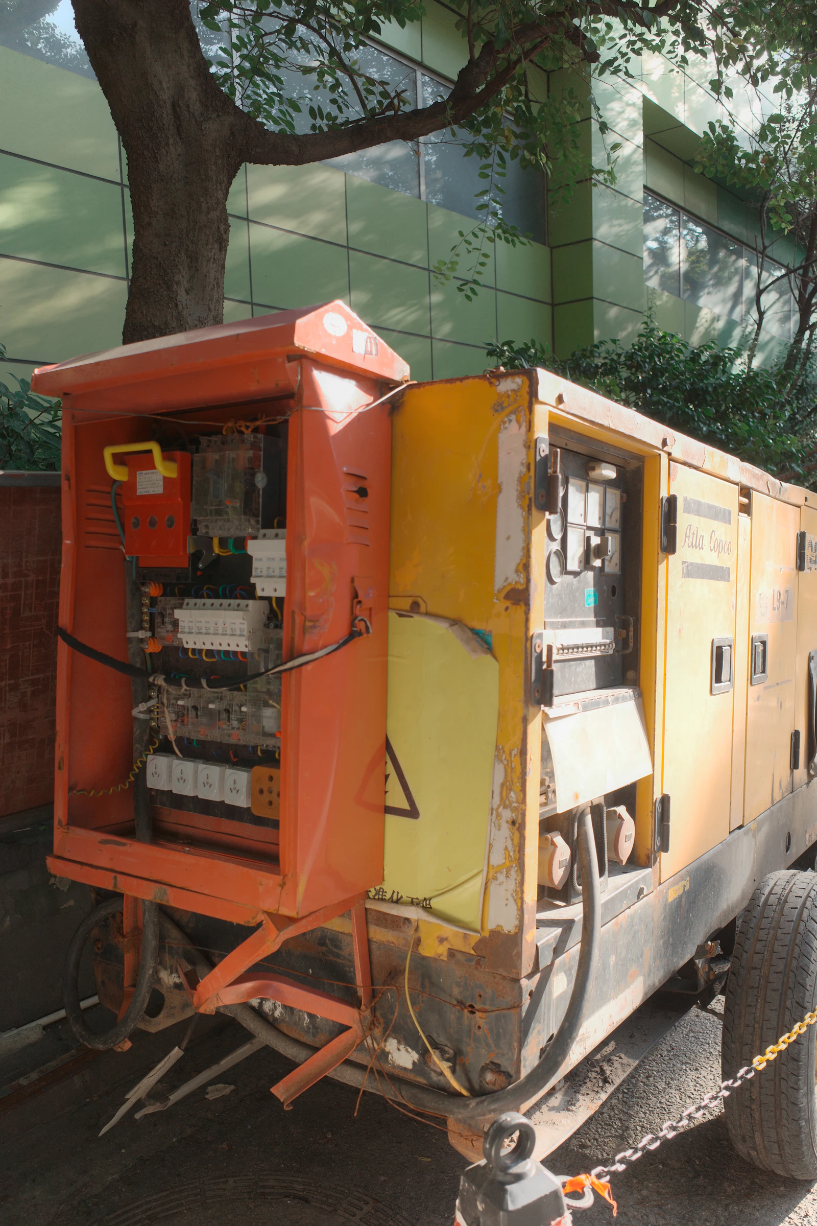 Standby generator with its electrical panel open, showing internal components