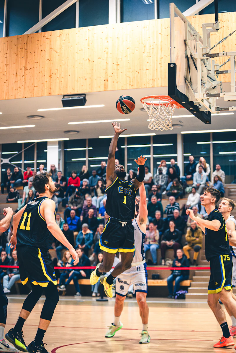 Basketball player jumping to score a basket during a game