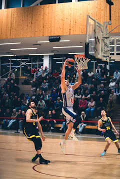 Basketball player dunks the ball during a game