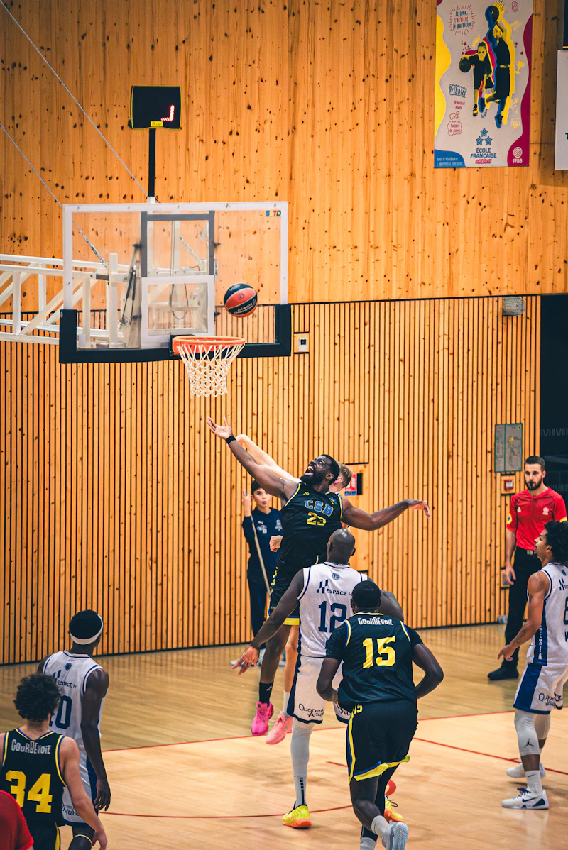 Basketball players jumping for a rebound during a game