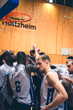 Basketball players huddle together during a game.