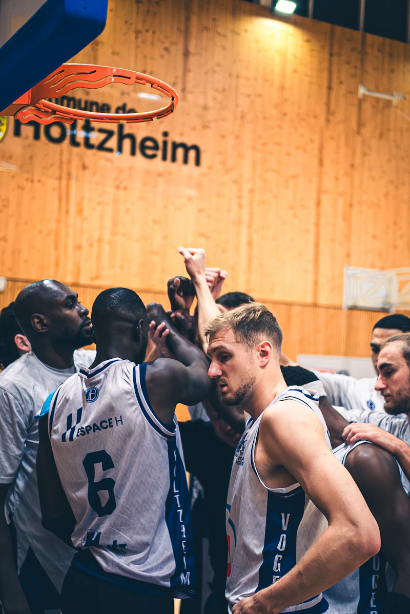 Basketball players huddle together during a game
