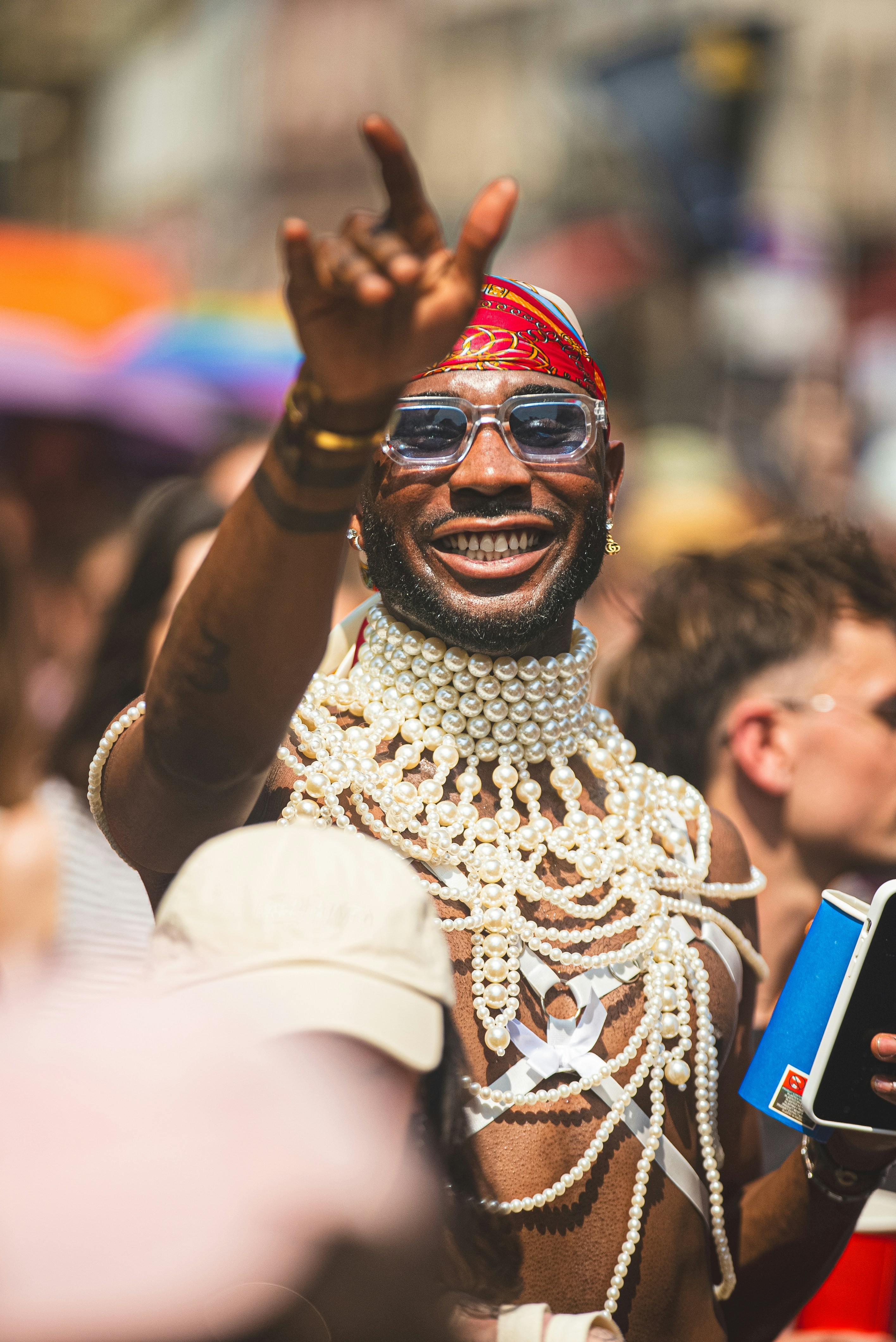 Man in ornate necklace and headscarf at parade
