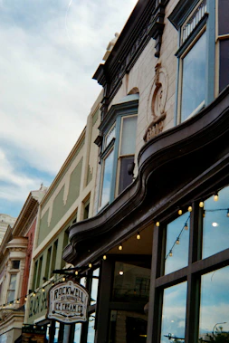 Historic buildings with string lights and ice cream shop sign