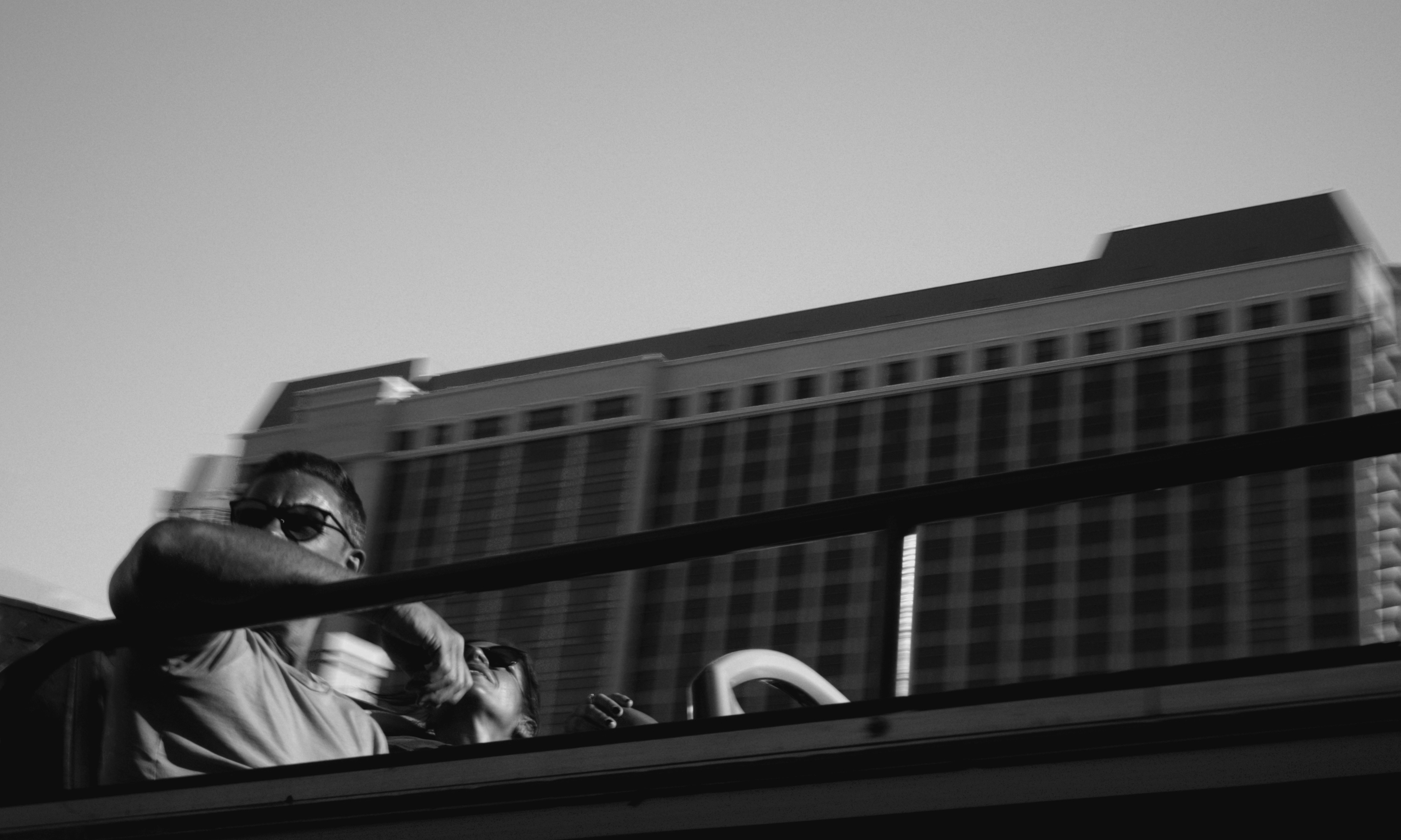 건물 배경이 있는 버스에서 선글라스를 쓴 남자