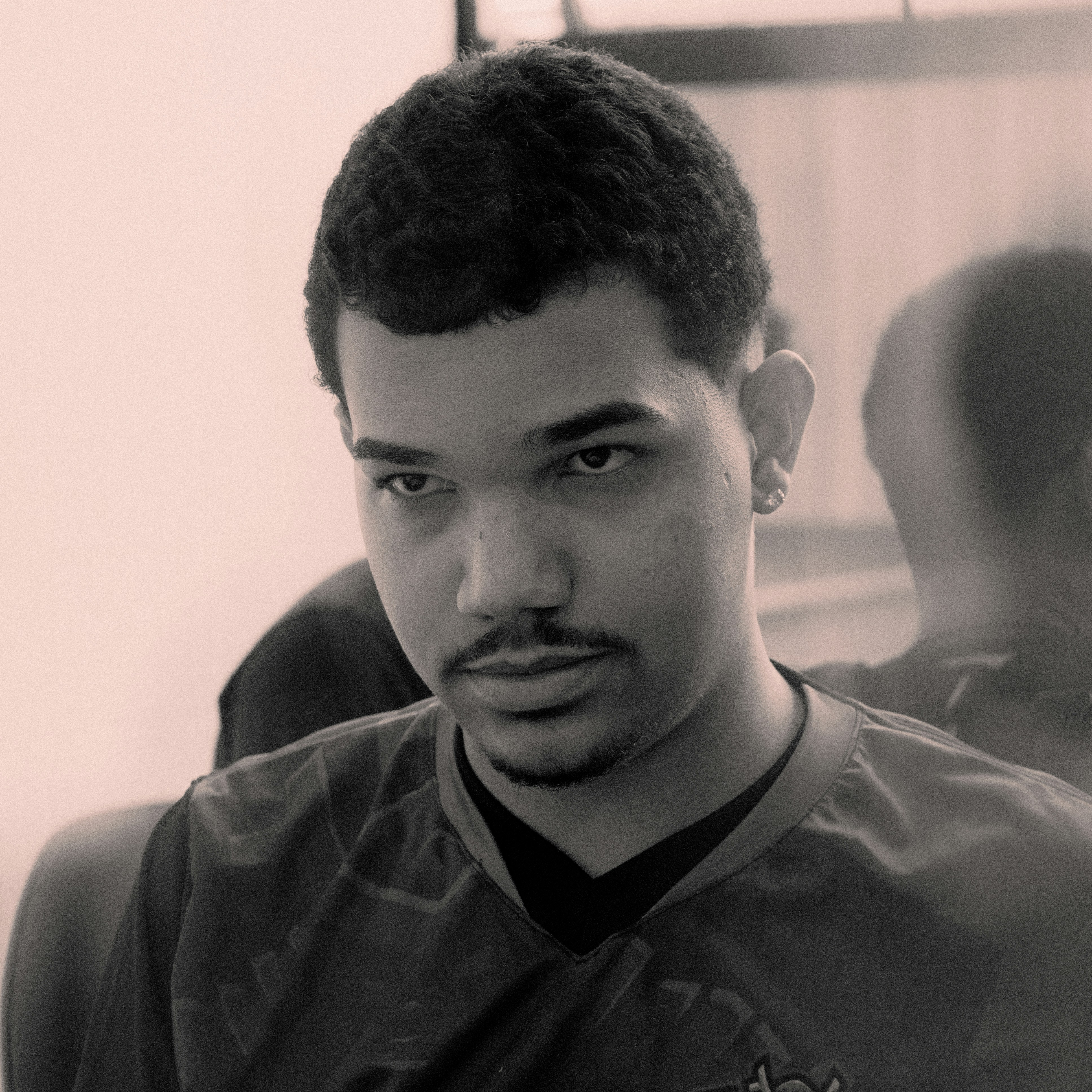 Young man with short dark hair and a mustache