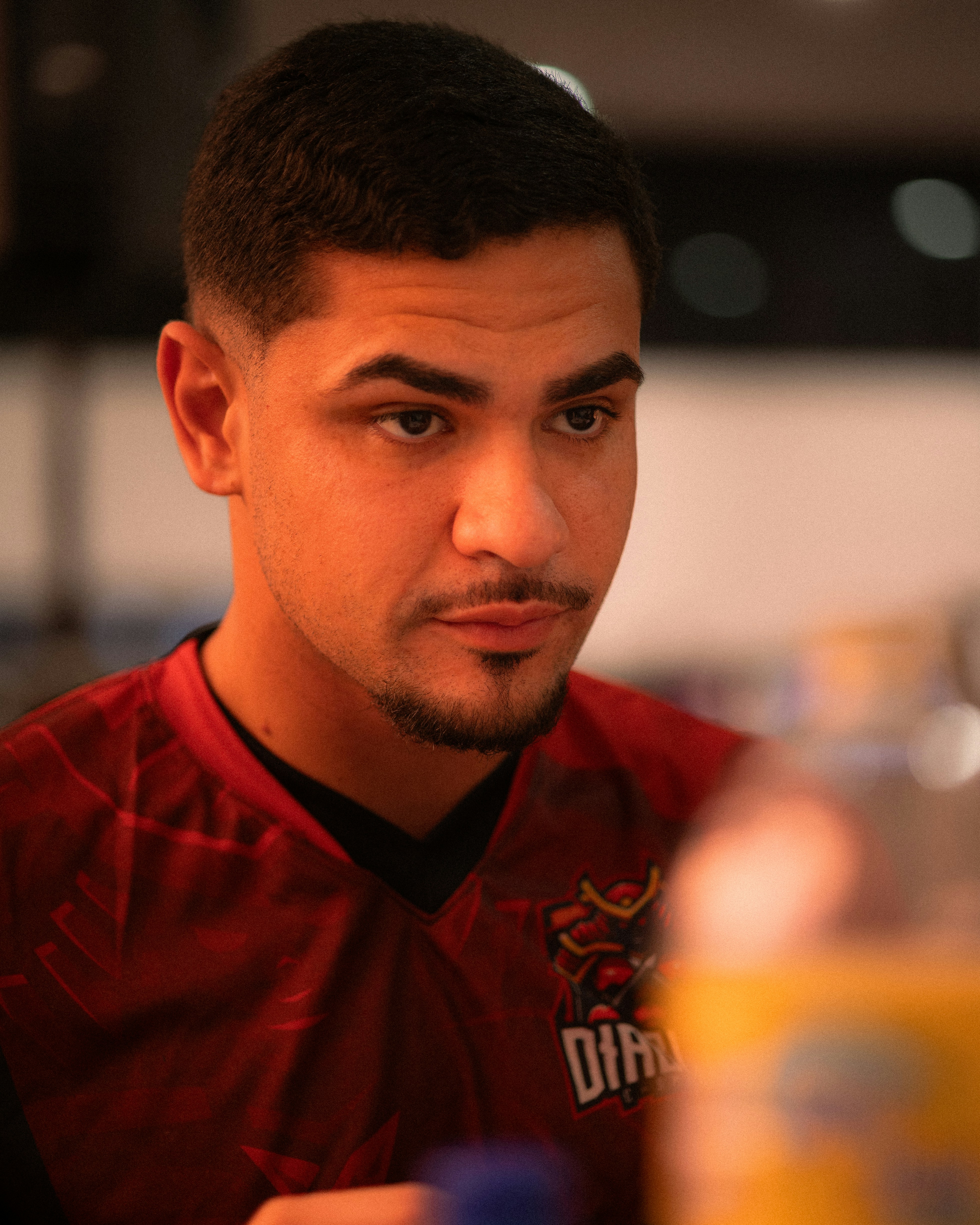 Young man wearing a red and black sports jersey