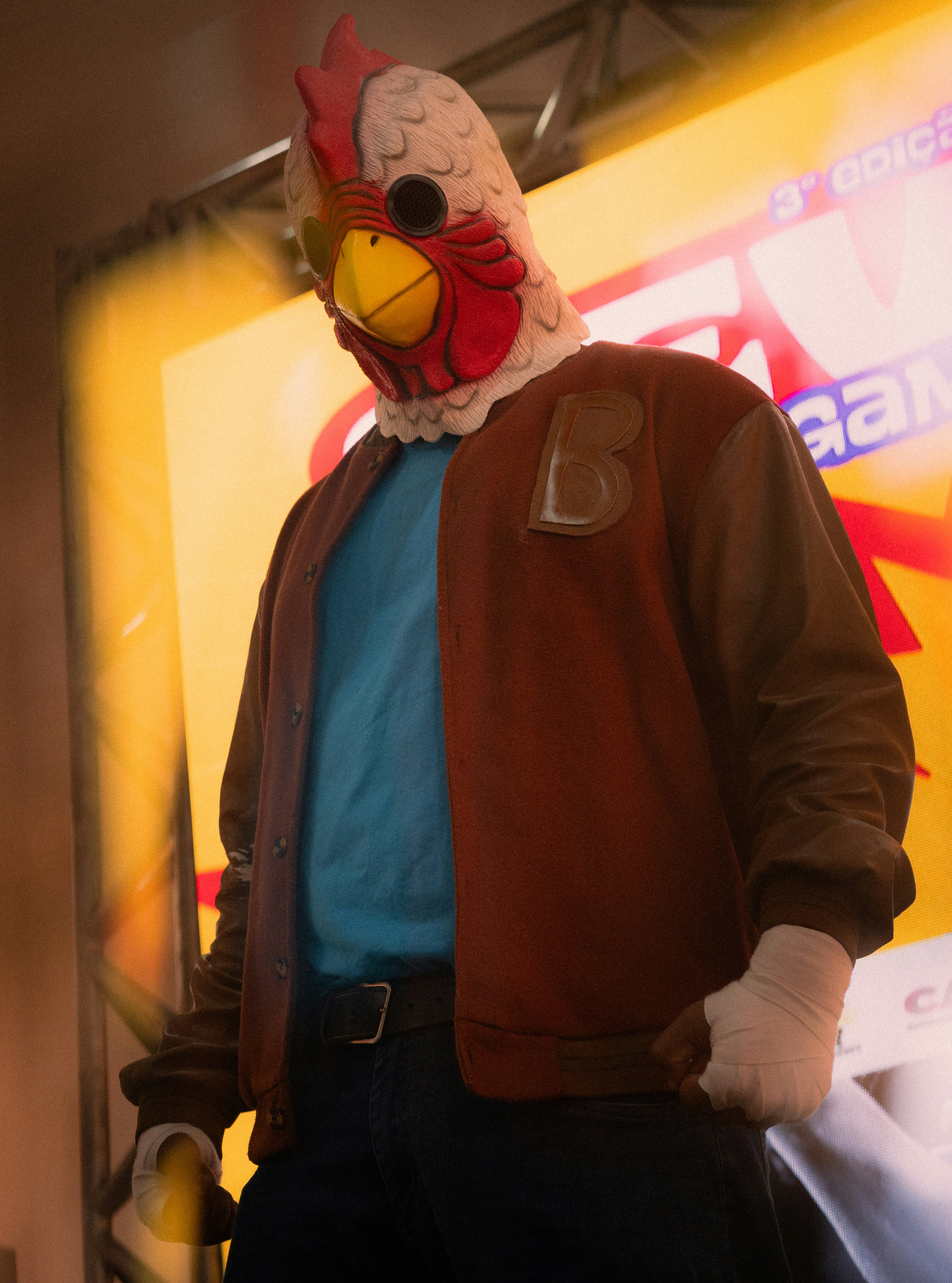 Man wearing a chicken mask and jacket