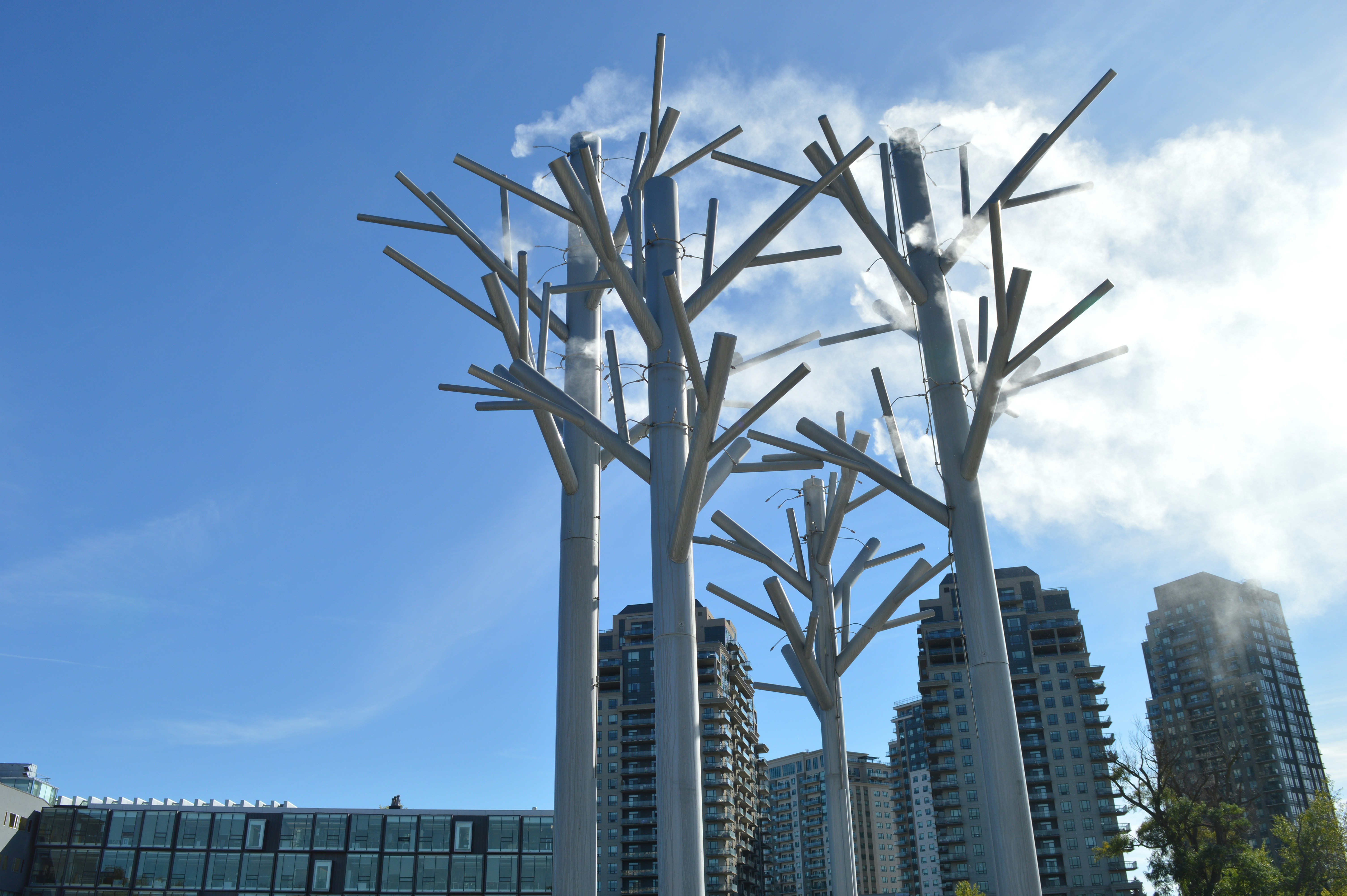 Modern tree sculptures against a blue sky
