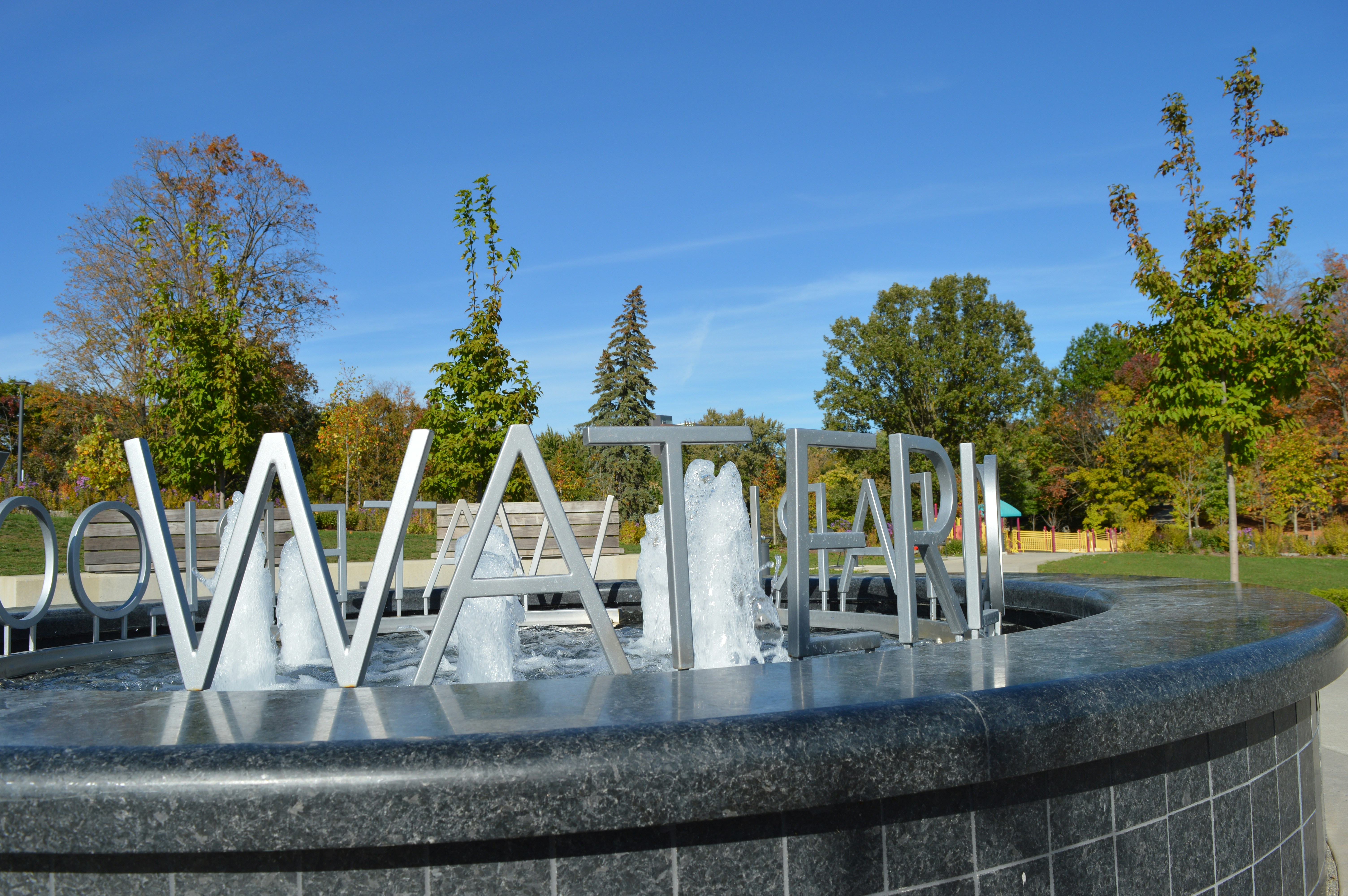 Metal letters spelling water in a fountain