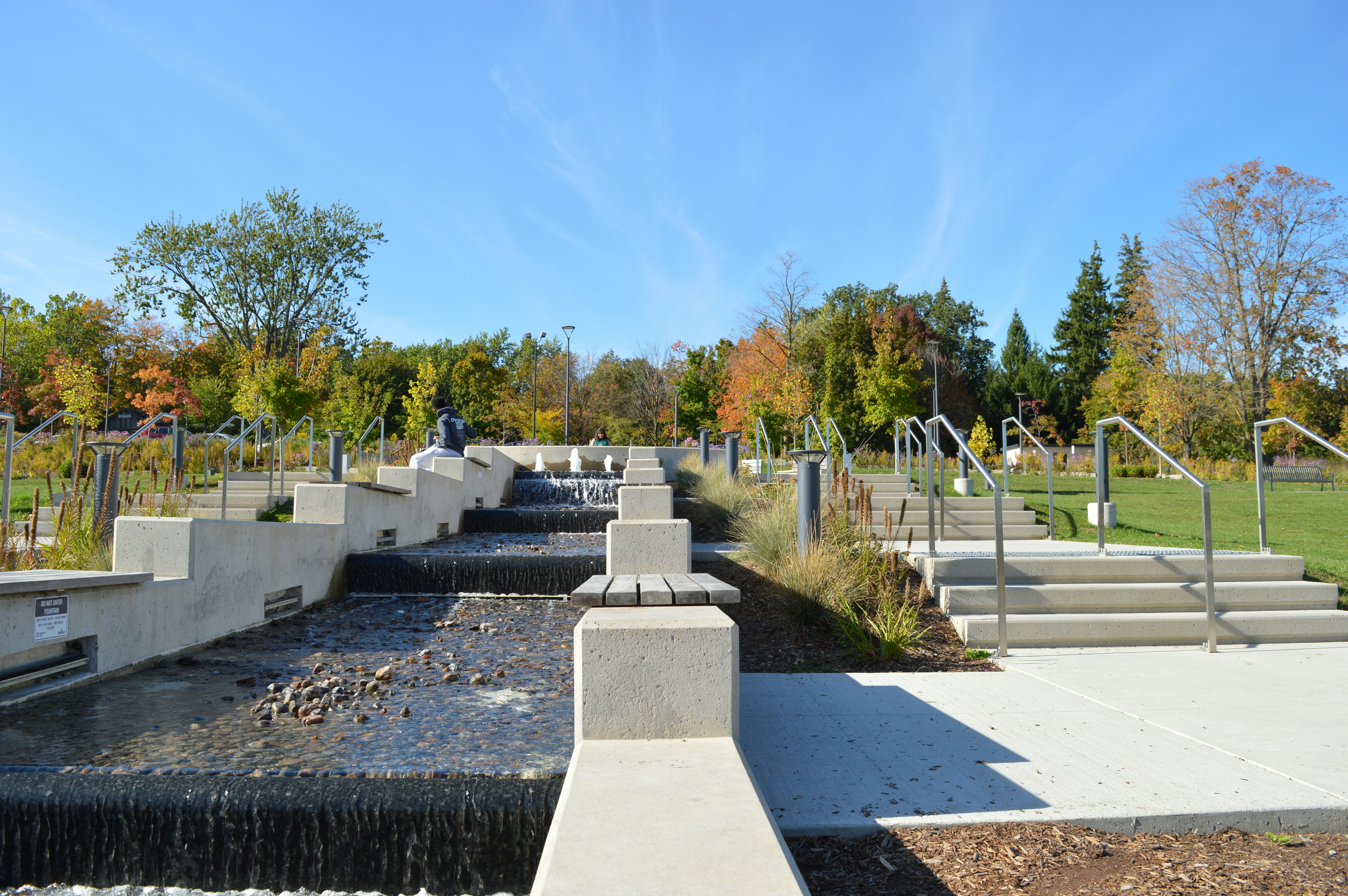 Modern tiered water feature with stairs in park