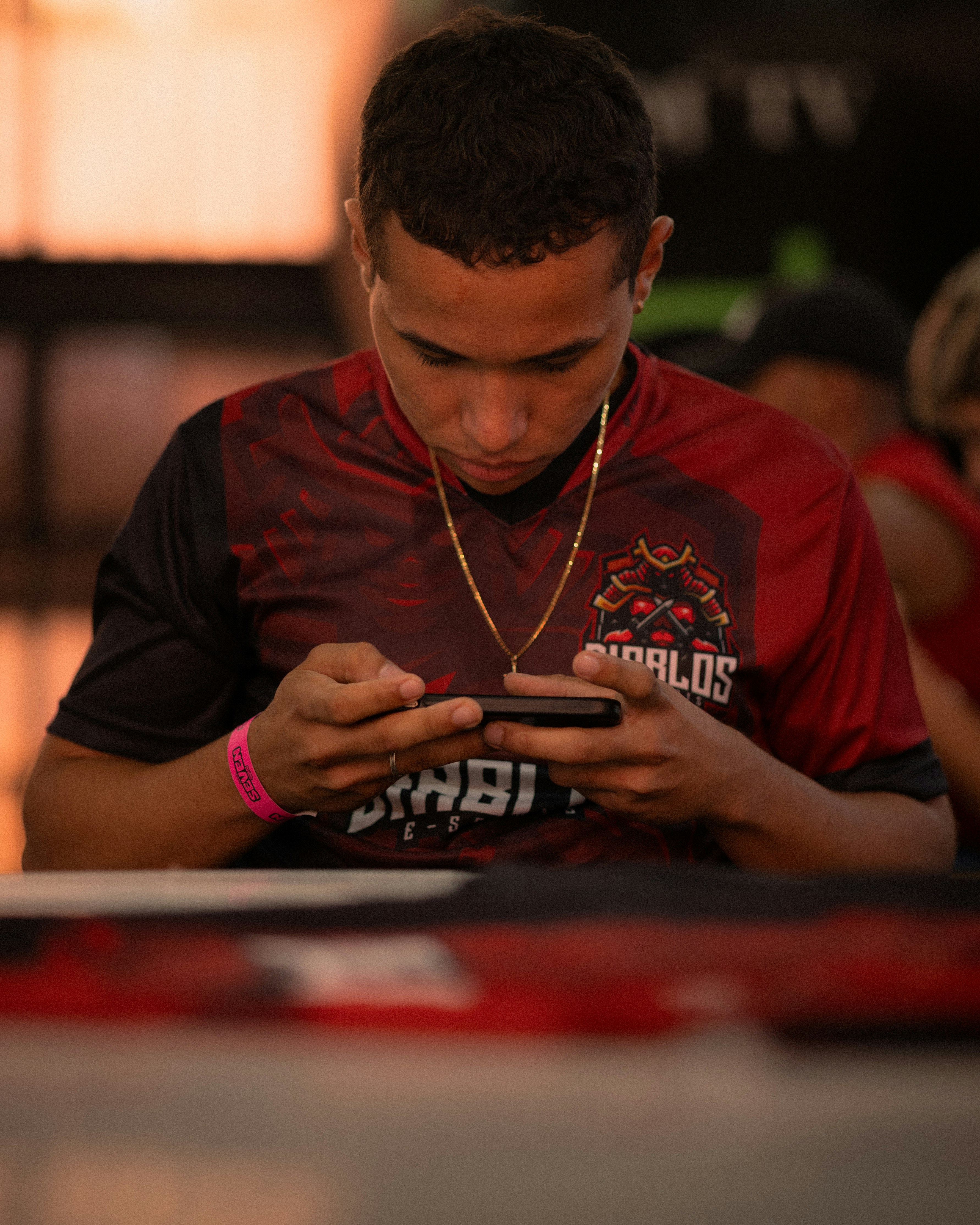 Young man playing a game on his smartphone indoors
