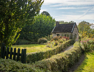A quaint cottage surrounded by a lush garden.
