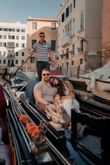 Couple enjoys a gondola ride in venice canal.