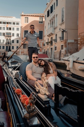 Couple enjoys a gondola ride in venice canal.