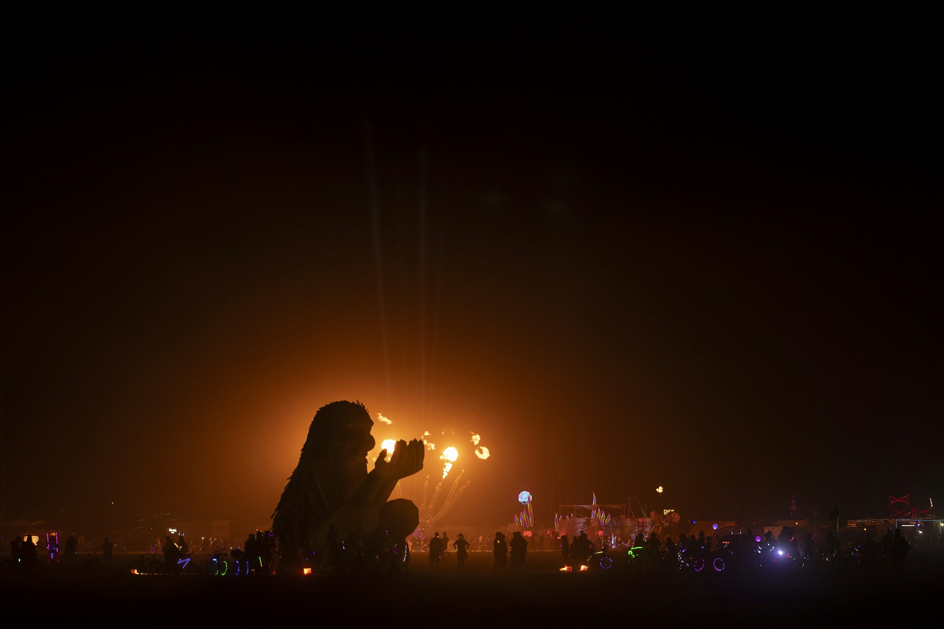 Silhouette of a person against a bright light display.