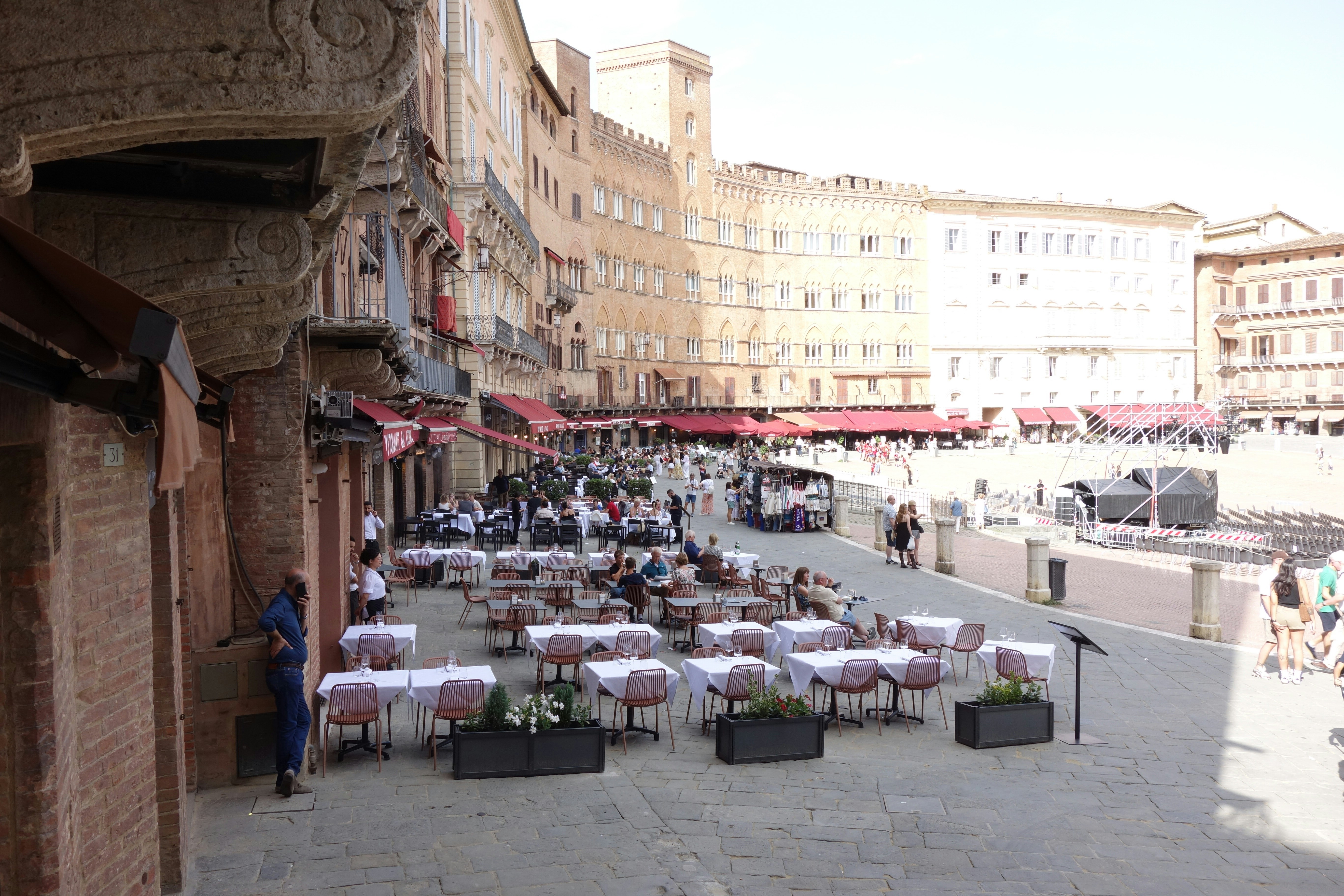 Outdoor cafe tables set up in a european piazza.
