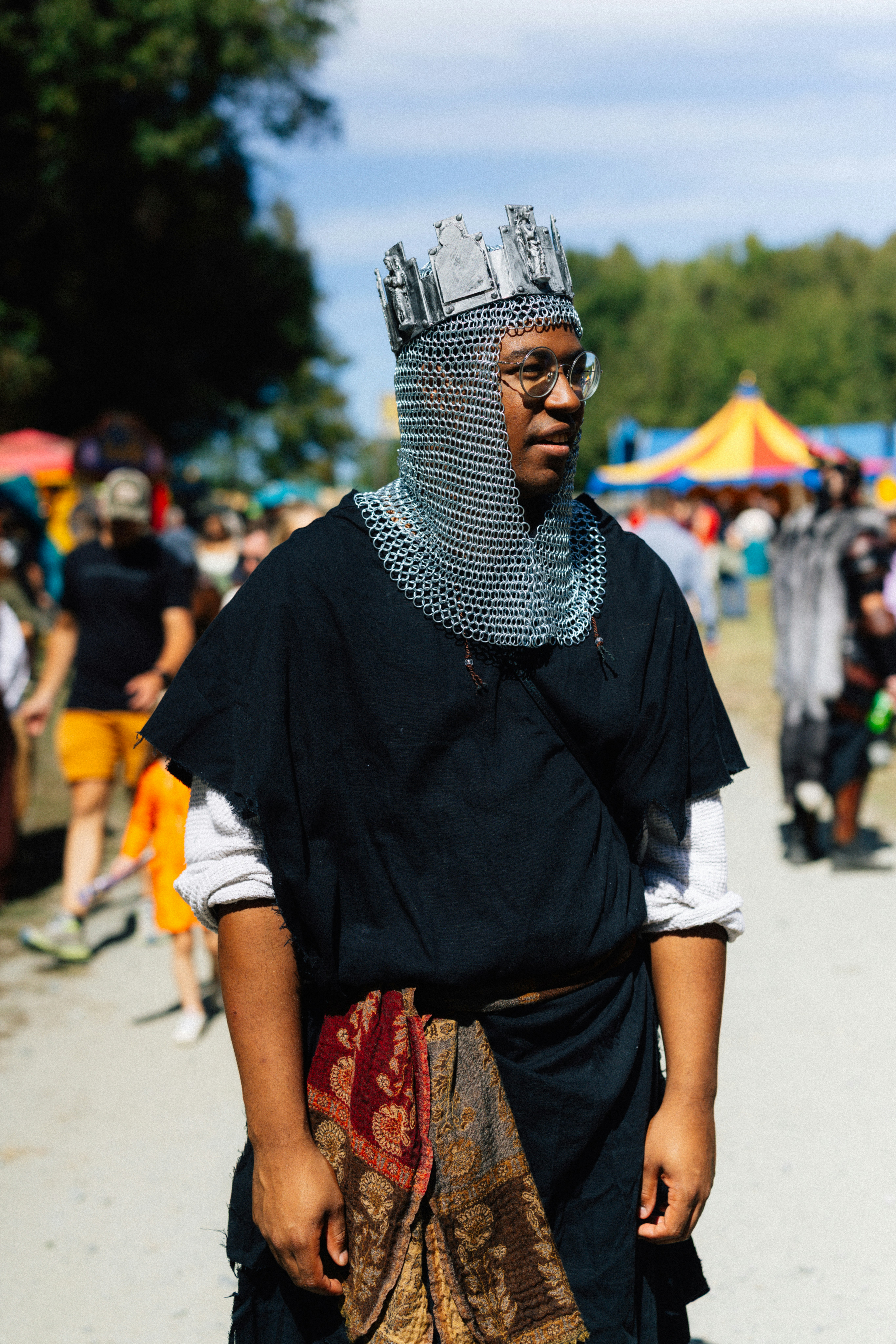 Man in chainmail and crown at festival