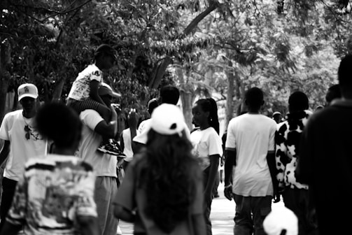 People walking together outdoors in black and white.