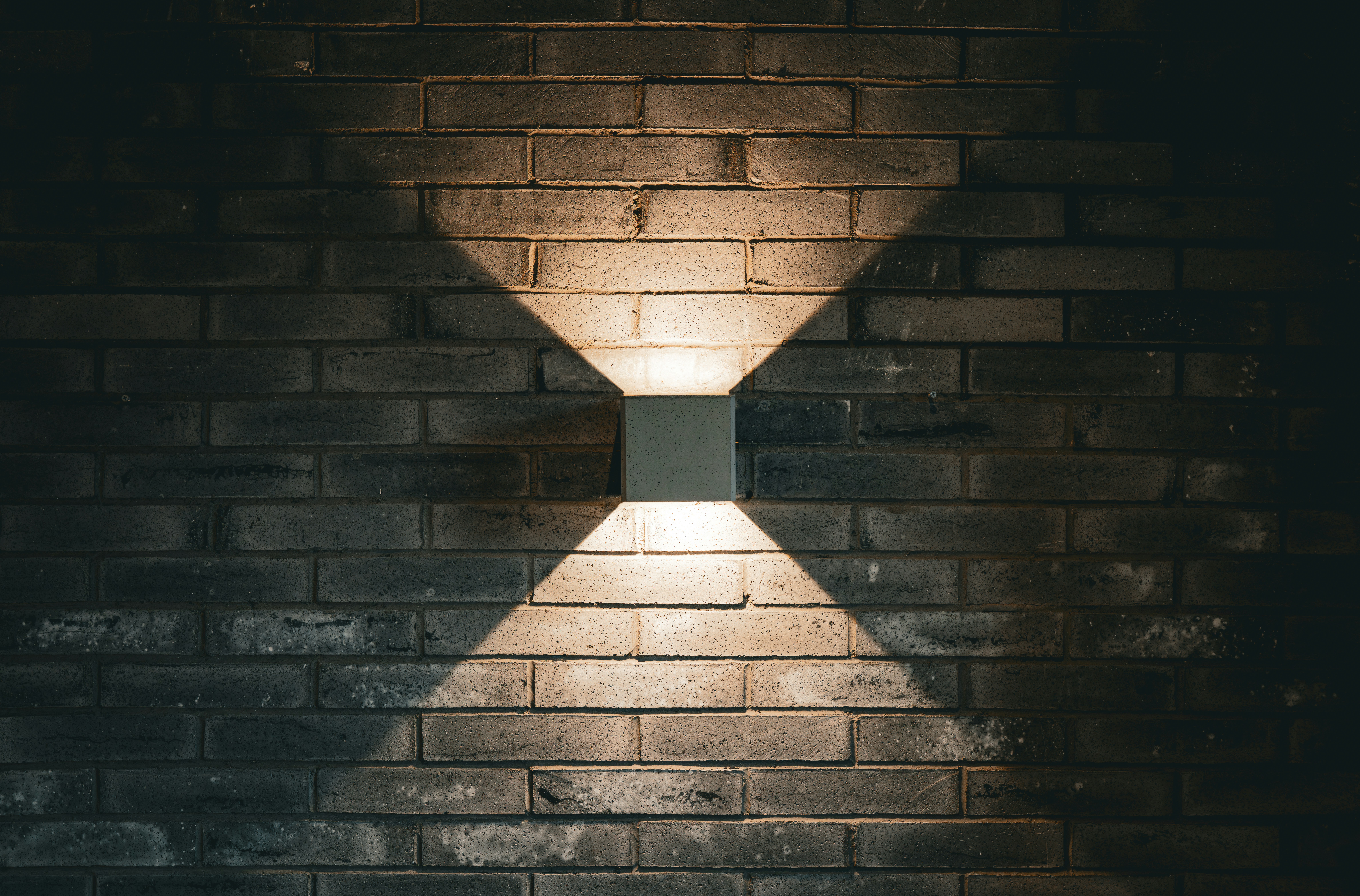 Square light fixture on a brick wall
