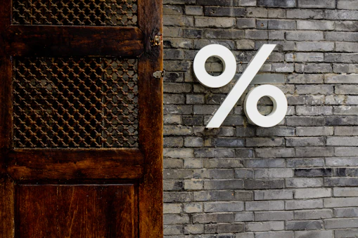 White percentage sign on a brick wall
