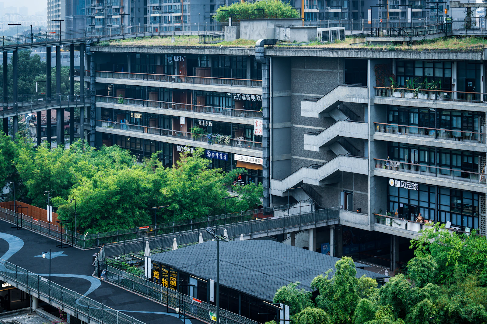 West Village Basis Yard, Chengdu. Green terraces and planting acquire meaning when combined with a low-embodied-carbon structure and a high-performance building envelope — not on their own.