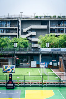 Multisport court with basketball hoop and goals.
