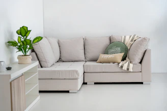 A modern sectional sofa with decorative pillows and throw.