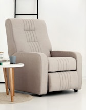 A beige recliner chair next to a small table.