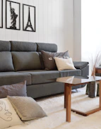 Gray sofa with decorative pillows and artwork