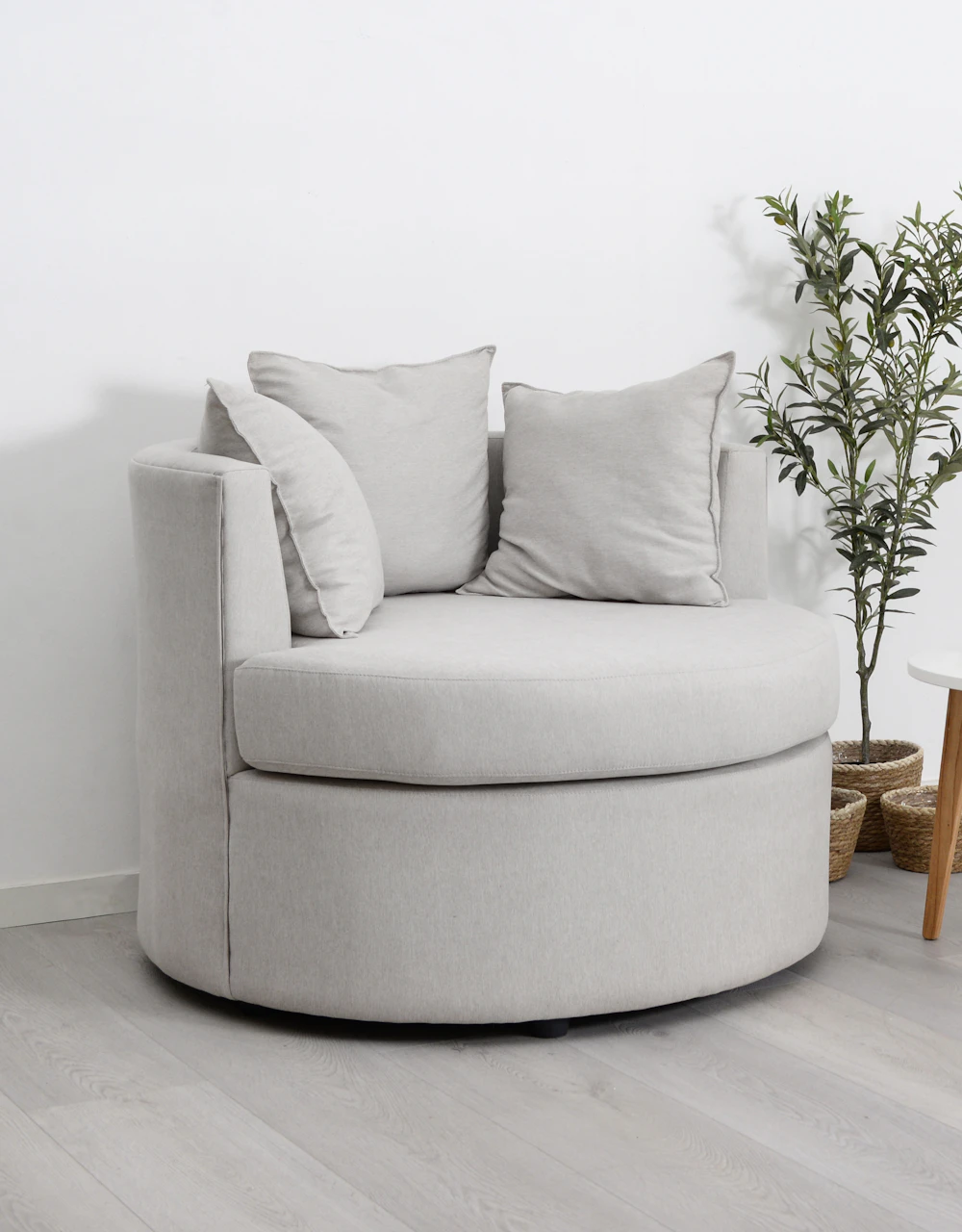 Soft round accent chair in a neutral interior