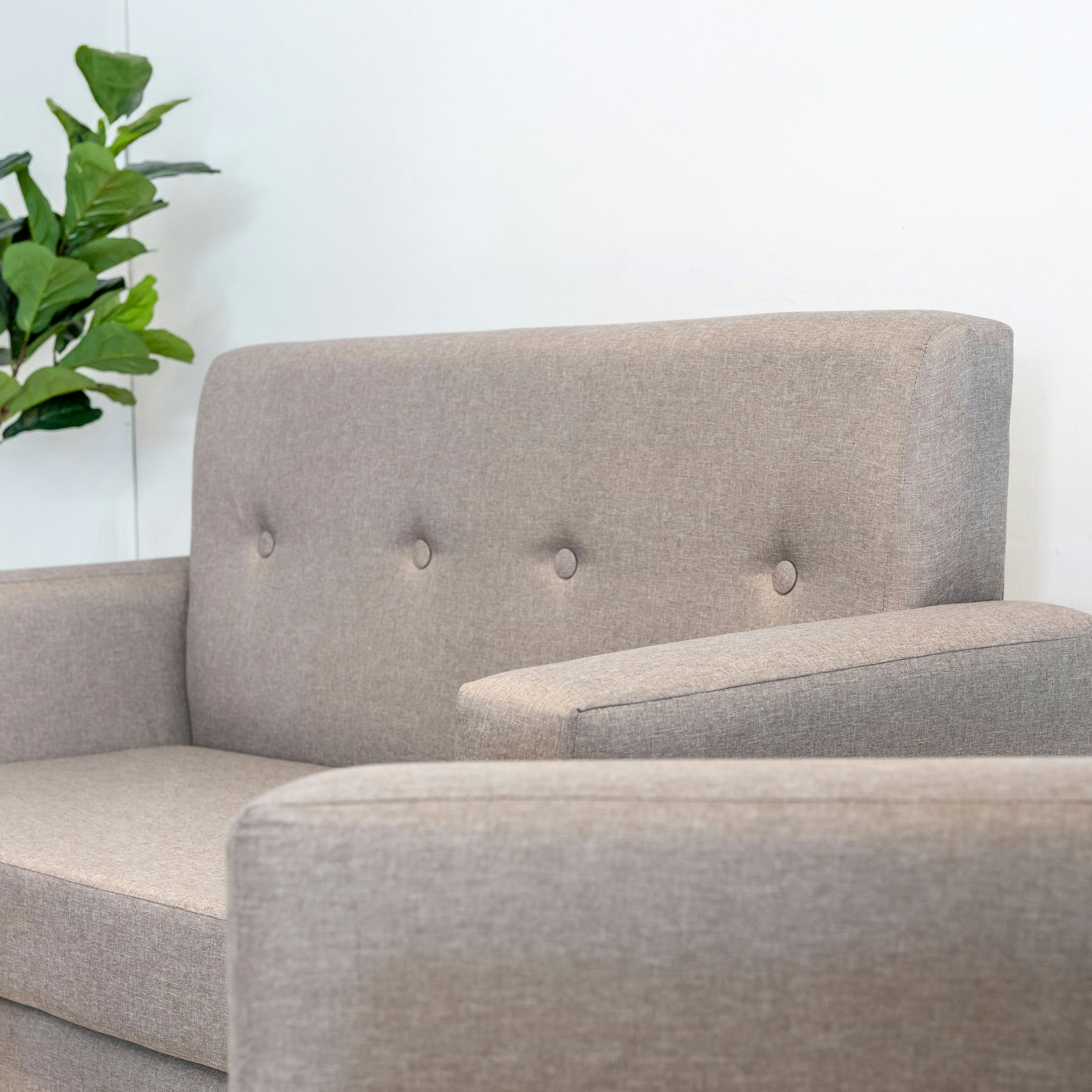 A modern gray sofa with tufted backrest