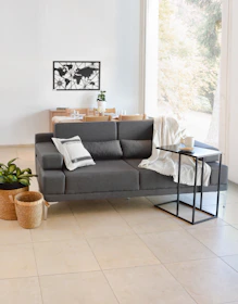Modern living room with gray sofa and world map art.
