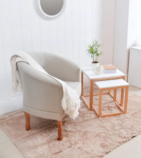 Cozy armchair with throw blanket next to side tables.