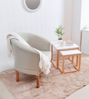 Cozy armchair with throw blanket next to side tables.